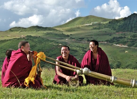 Monks playing Musical Instruments on the grass